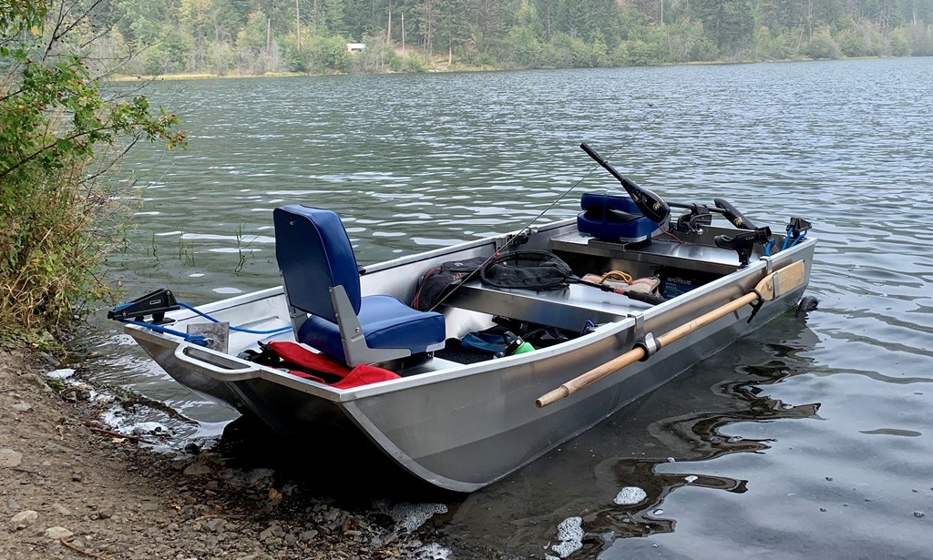 Stillwater aluminum boat rigged with seats, oars, rods, and practical storage